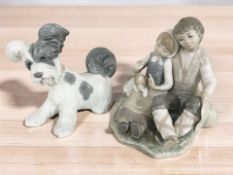 A Lladro figure group of a boy, girl and a puppy, and a further Lladro dog.