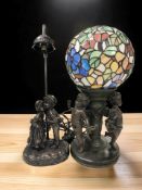 Two contemporary patinated resin lamp bases, one with Tiffany-style globular stained glass shade,