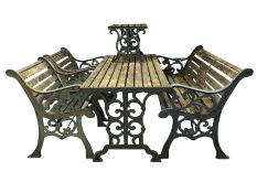 A five piece cast iron and weathered teak garden patio set comprising of a rectangular table,