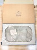 A white lace wedding gown, in protective case.