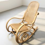 A Thonet-style curved bentwood and cane rocking chair, width 54 cm.