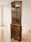 A reproduction walnut corner cabinet, height 183 cm.