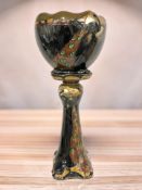 A glazed earthenware jardiniere on pedestal depicting a peacock, height 94 cm.