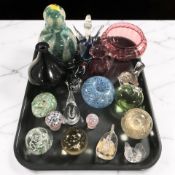 A group of studio glass paperweights, bowls, large scent bottle and stopper.