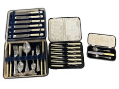 A group of cased cutlery sets, cased silver fork and spoon.