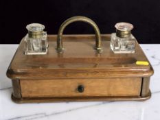 A Victorian oak desk stand with two glass ink wells, width 31 cm.