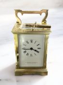 A brass carriage timepiece signed 'Northern Goldsmiths Co, Newcastle Upon Tyne', with key,