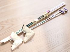 A pair of skis, poles and ski boots.