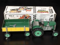 A Czech tin plate model tractor and trailer, with box, length 30 cm.
