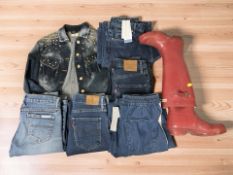 Assorted lady's belts, Levi and other denim jeans, denim jacket, pair of Hunter wellies.
