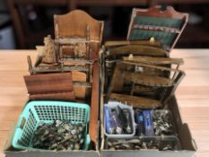 A group of wooden spoon racks and a large quantity of collector's spoons.