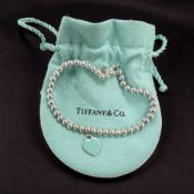 A Tiffany & Co silver 'Return to Tiffany' bracelet with enamelled heart-shaped fob, length 17cm,