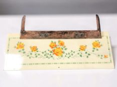 An Arts & Crafts embossed copper fire curb and an enameled panel, width 120 cm.