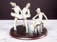 Two Lladro figures of ballerinas No. 5499 and 5497, on an oval plinth.