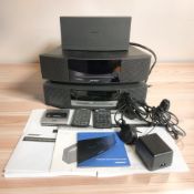 Three Bose Wave music systems, with various instruction booklets, leads and remotes.