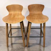 A pair of Scandinavian bent and laminated wood stools, height 82 cm.