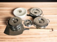 A group of Aga stainless steel cooking pans, a pizza shovel, etc.