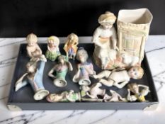 A group of porcelain half-dolls and a figural spill vase.