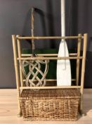 A wicker hamper, a folding card table, a bamboo towel rail, an oar and a carpet beater.