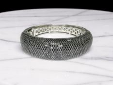 A silver and black cubic-zirconia hinged bangle by 'Ti Siento', inner diameter 6cm.