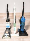 A Vax carpet cleaner, Hoover vacuum and a Shark floor cleaner.