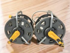 Two hosepipes on reels.