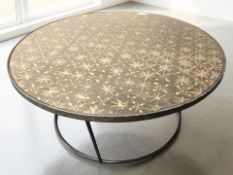 A Notre Monde black metal and glass topped circular coffee table, diameter 91 cm.