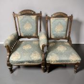 A pair of late Victorian carved walnut salon chairs, the armchair 72 cm wide.