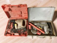 Two hammer drills in cases.
