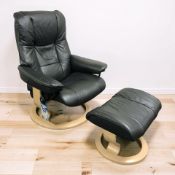 A Norwegian Ekornes stressless black stitched leather swivel lounge armchair,