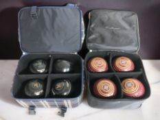Two bags containing lawn bowls.