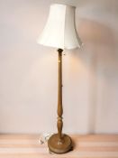 A turned beech standard lamp.