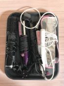 A group of hair curlers and straighteners.