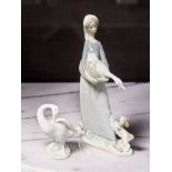 A Lladro figure of a lady holding a goose No. 4860, and a further figure of a goose.