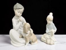 A Lladro figure of a boy with a dog No. 4522, and a further figure of a boy with a lamb.