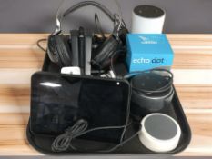 A group of Amazon Home speakers, a pair of Sony wireless headphones with charging dock.
