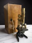An E Leitz London Wetzlar lacquered brass microscope, No. 117936, in wooden case.