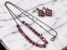 A silver and glass-filled ruby-set necklace and similar pair of cluster drop earrings