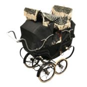 A Silver Cross doll's pram containing vintage dolls.
