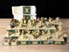 A collection of Collectible World Studios dragon ornaments with boxes.