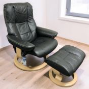 A Norwegian Ekornes stressless black stitched leather swivel lounge armchair,