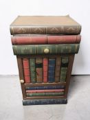 A modern storage cabinet in the form of a stack of books, height 60 cm.