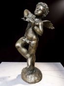 A contemporary hollow cast patinated bronze figure of a winged cherub musician playing a set of