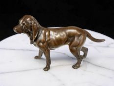 A patinated solid cast bronze figure of a dog, length 18 cm.