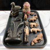 A group of wooden animal carvings, Russian babushka nesting doll, etc.