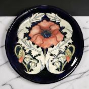 A Moorcroft Poppy plate, diameter 26 cm.
