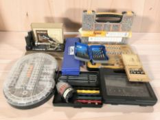 A group of tool sets including dremel accessories, a case of screws, sharpening tools, etc.