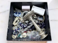 A loaded silver candlestick, height 14cm, and a small boxed of mixed silver and costume jewellery,