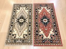 Two machine made Persian-style rugs, each 170 cm x 84 cm.