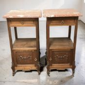 A pair of French walnut two tier bedside stands with rouge marble tops, circa 1900,